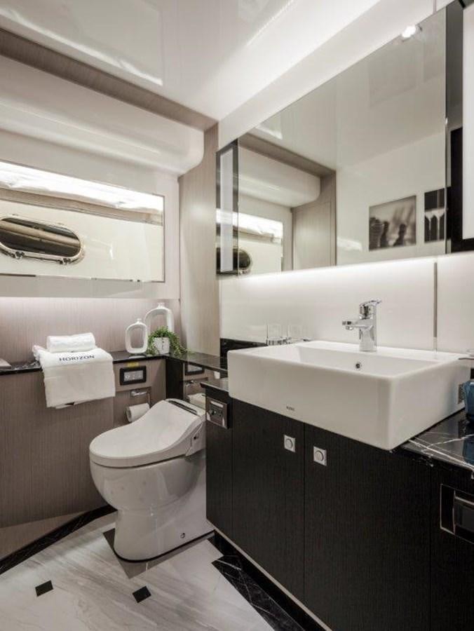 a bathroom with a sink toilet and a mirror aboard V72 (NEW BOAT SPEC)  Yacht for Sale