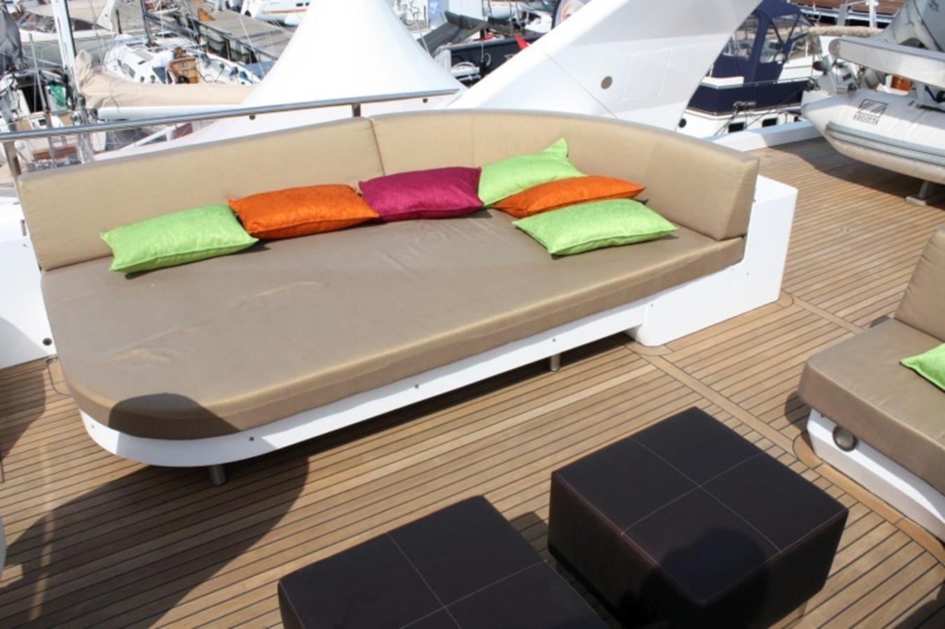 a bed with colorful pillows aboard BOADICEA Yacht for Sale