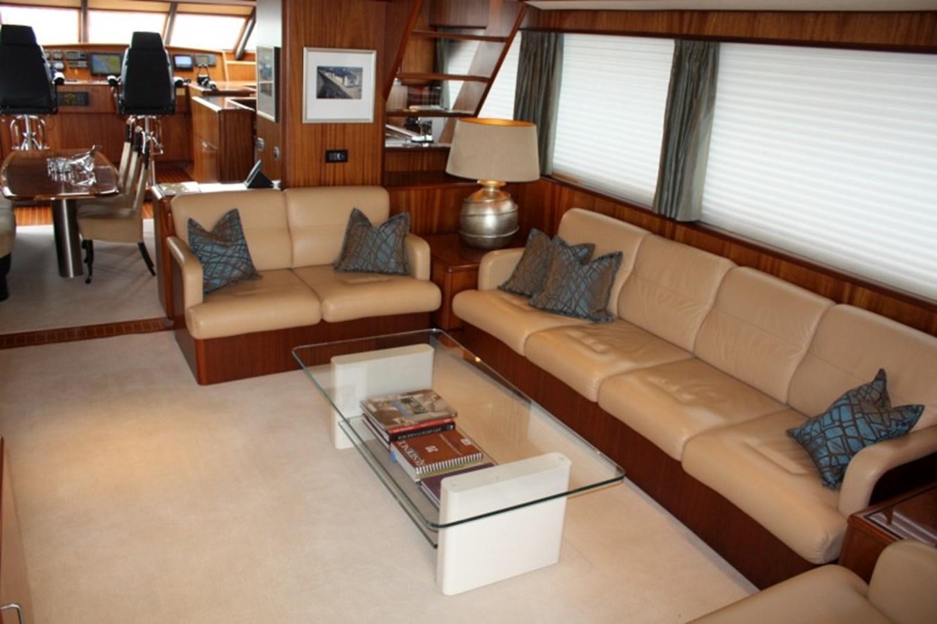 a living room with a couch and coffee table aboard BOADICEA Yacht for Sale