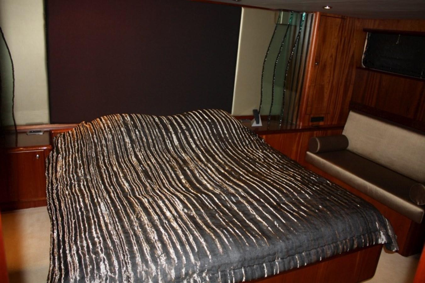a bed with a blue sheet aboard BOADICEA Yacht for Sale
