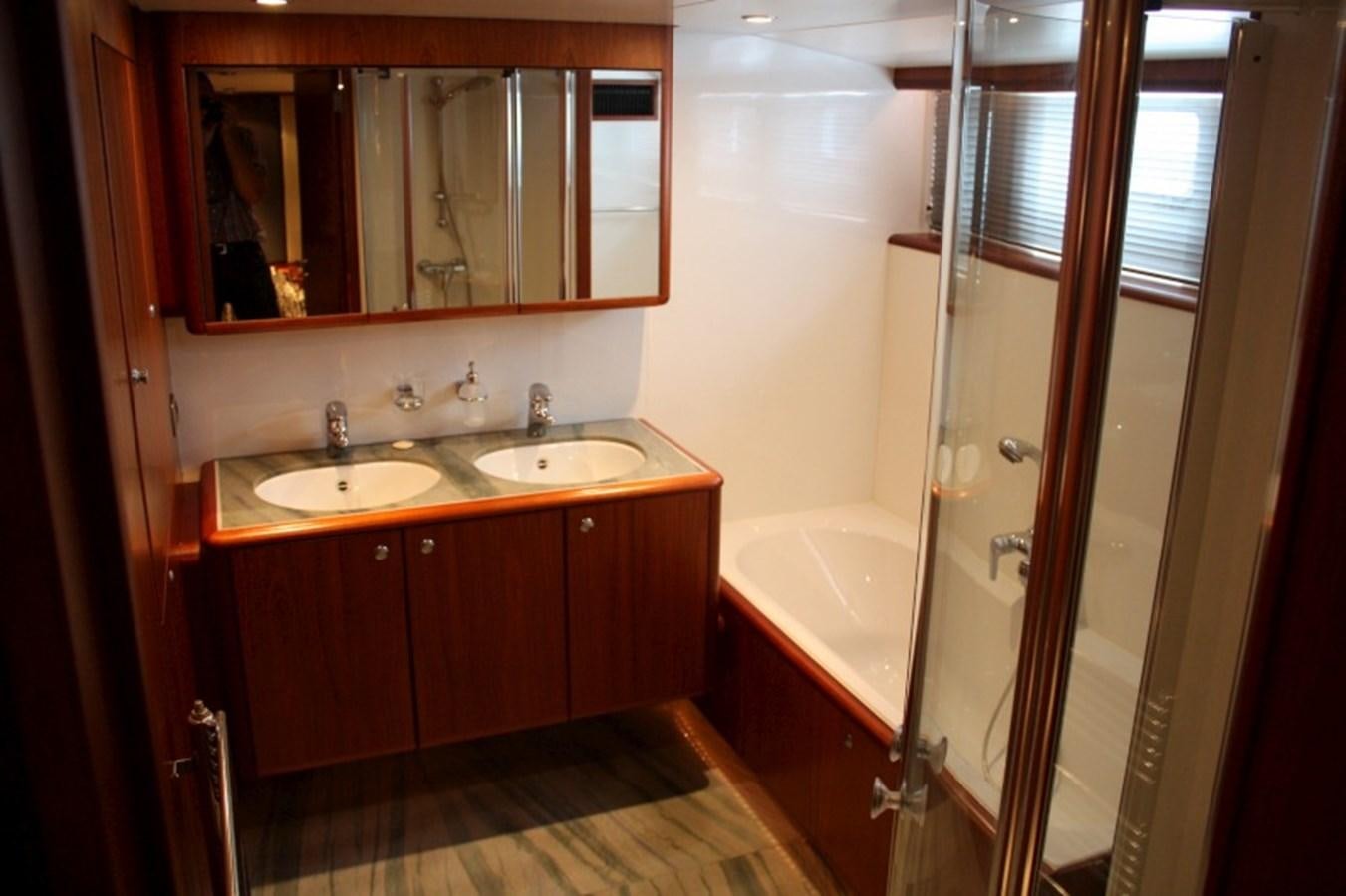 a bathroom with a tub sink and sink aboard BOADICEA Yacht for Sale