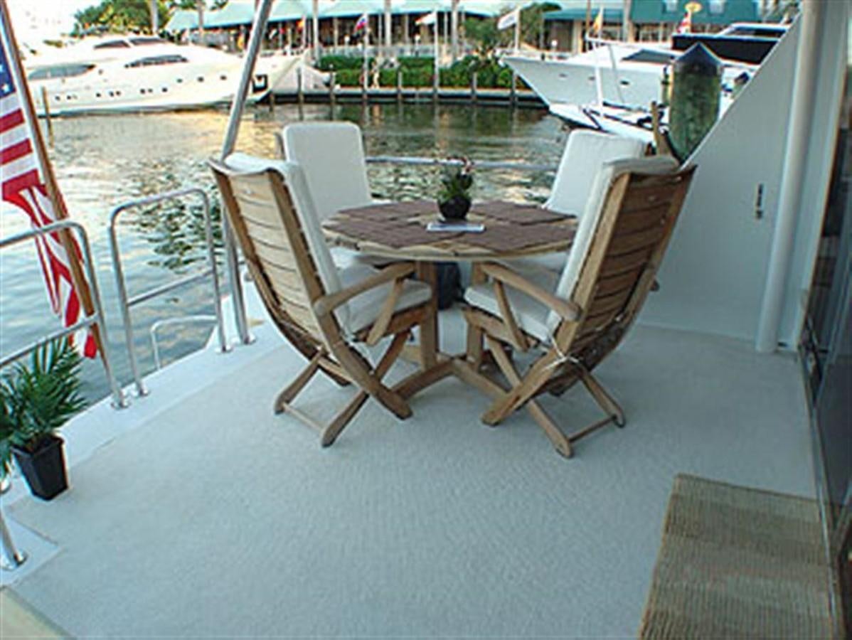 a table and chairs on a patio aboard WHALE'S WAY Yacht for Sale