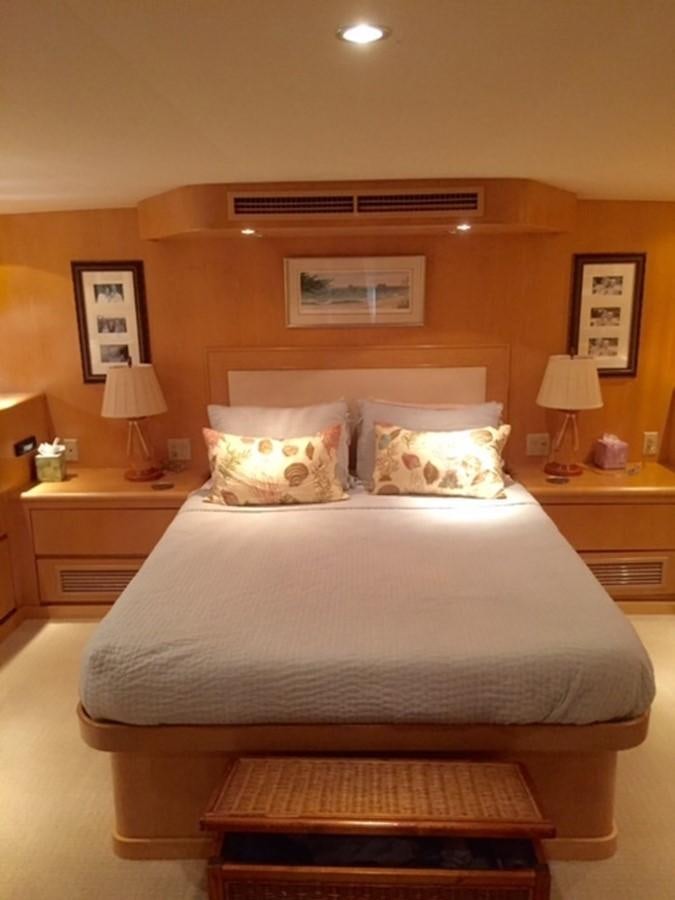 a bed with a pillow and a lamp on it aboard WHALE'S WAY Yacht for Sale