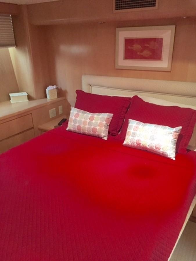 a bed with red pillows aboard WHALE'S WAY Yacht for Sale