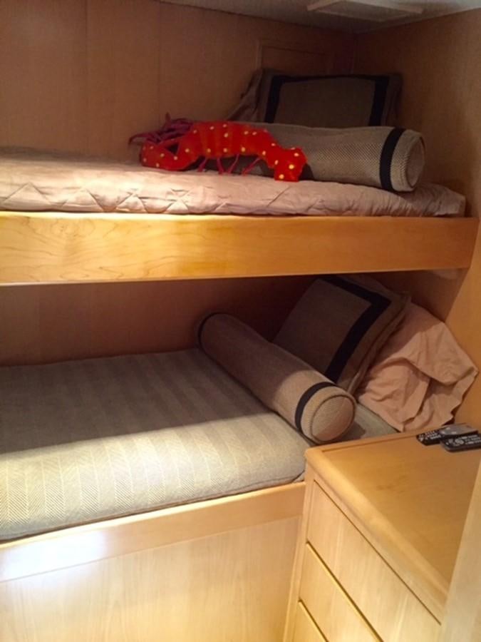 a bed with pillows and blankets aboard WHALE'S WAY Yacht for Sale