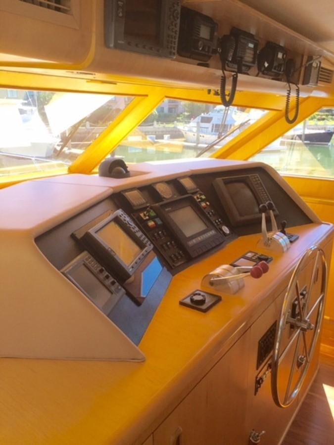 a yellow bus with a large yellow bus in the background aboard WHALE'S WAY Yacht for Sale