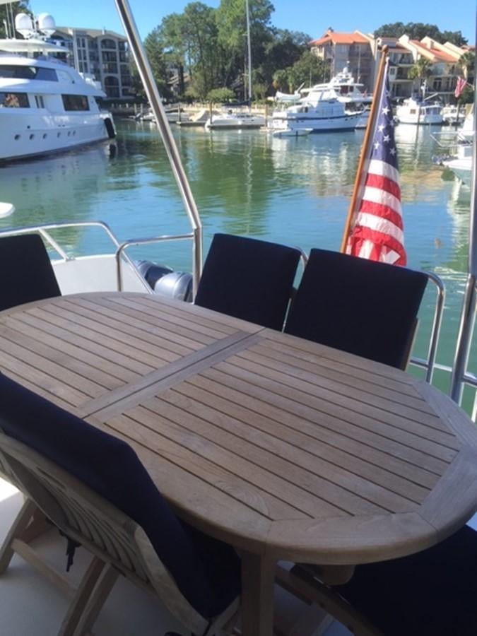a table with chairs on it by a body of water aboard WHALE'S WAY Yacht for Sale
