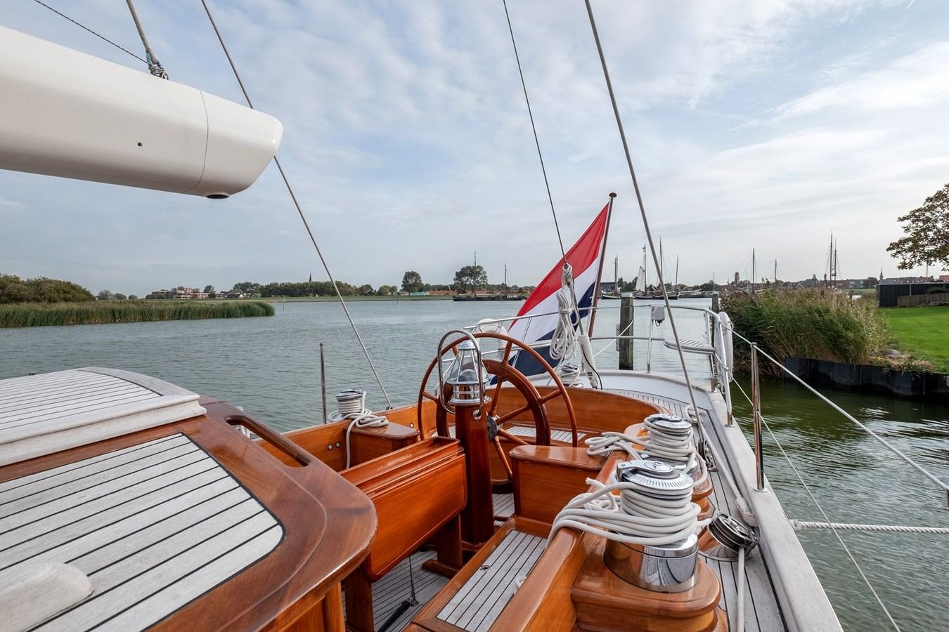 a boat with a red sail aboard HOEK CLASSIC 73 DIXBAY Yacht for Sale