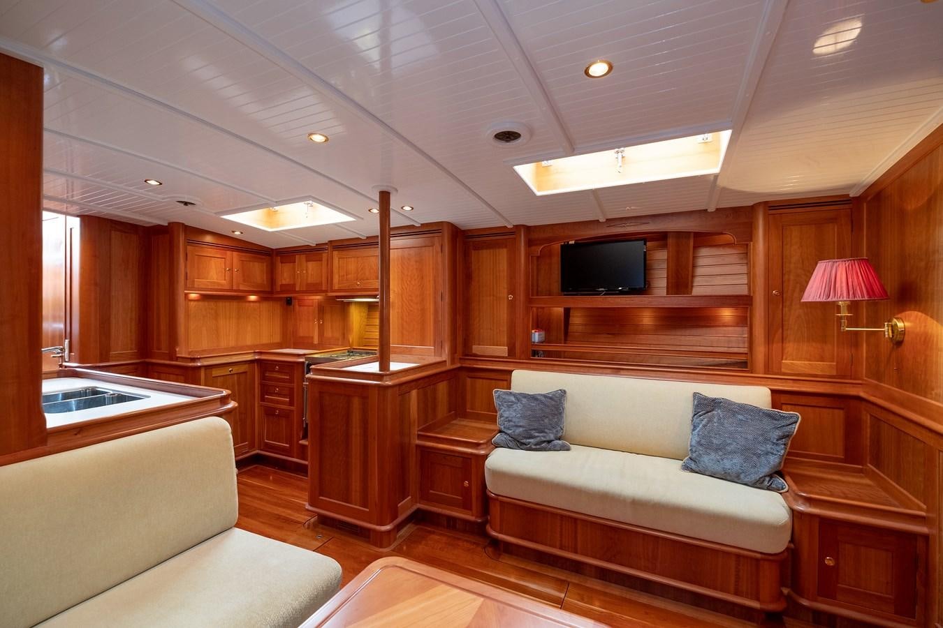 a living room with a couch and a television aboard HOEK CLASSIC 73 DIXBAY Yacht for Sale
