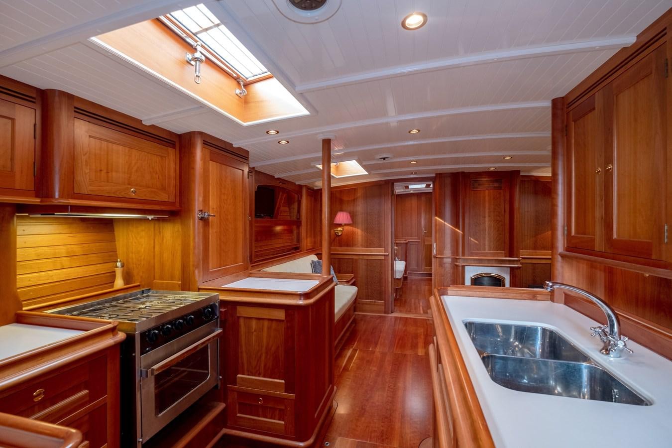 a kitchen with wooden cabinets aboard HOEK CLASSIC 73 DIXBAY Yacht for Sale