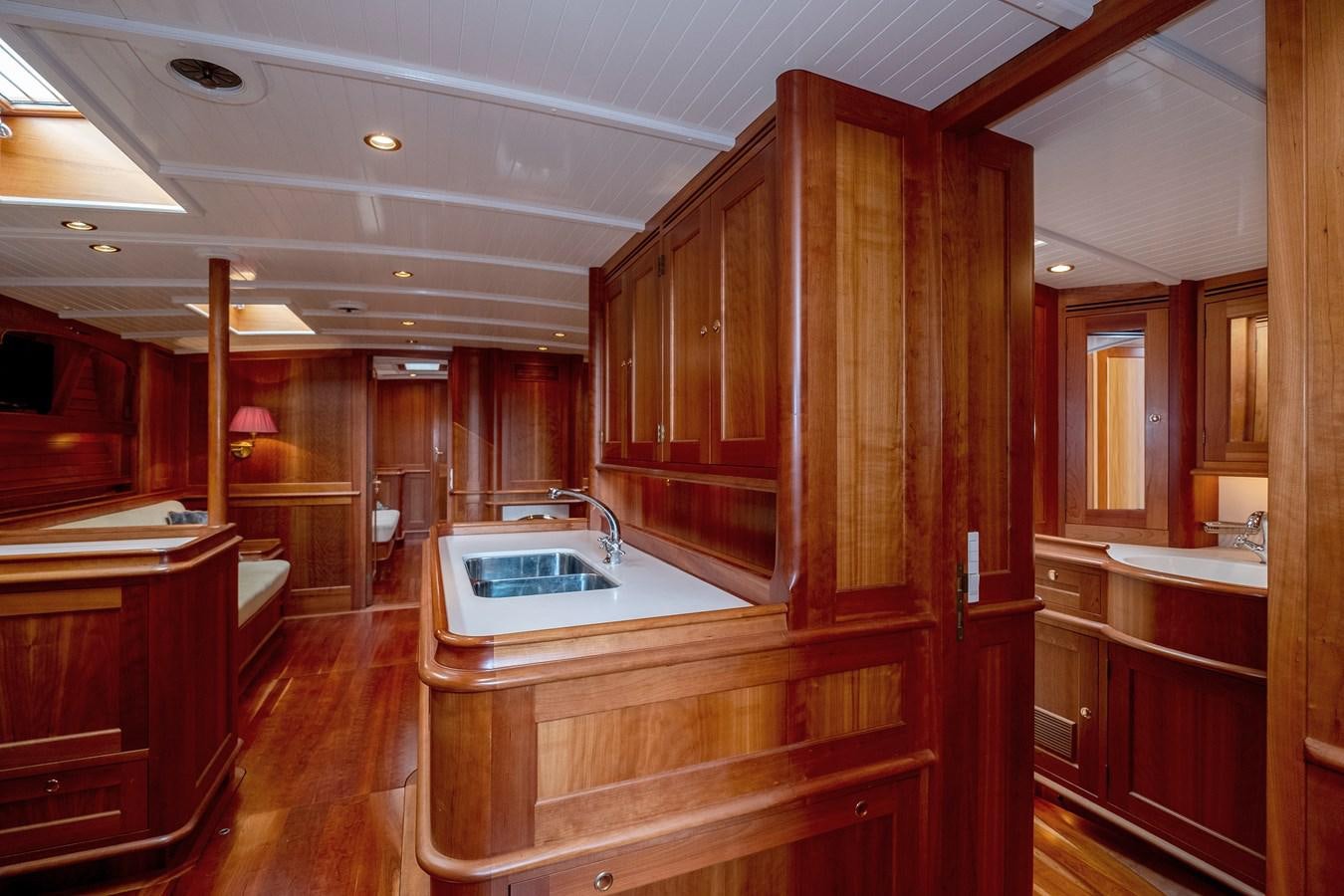 a kitchen with wooden cabinets aboard HOEK CLASSIC 73 DIXBAY Yacht for Sale