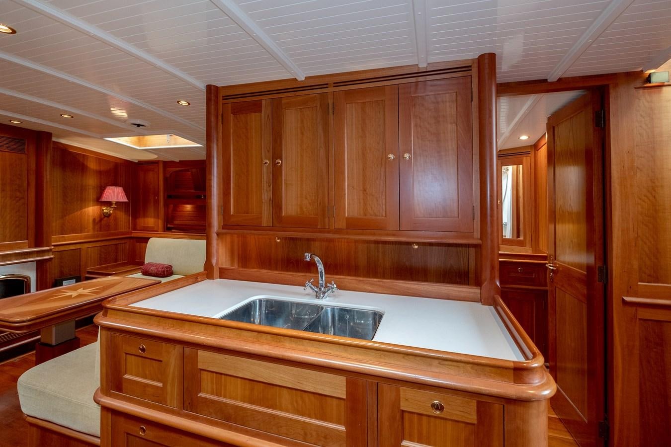 a kitchen with wooden cabinets aboard HOEK CLASSIC 73 DIXBAY Yacht for Sale