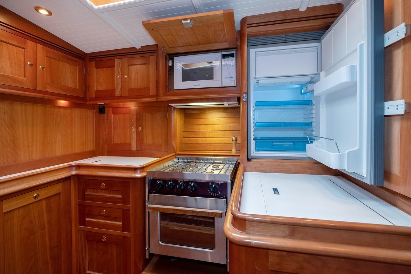 a kitchen with wooden cabinets aboard HOEK CLASSIC 73 DIXBAY Yacht for Sale