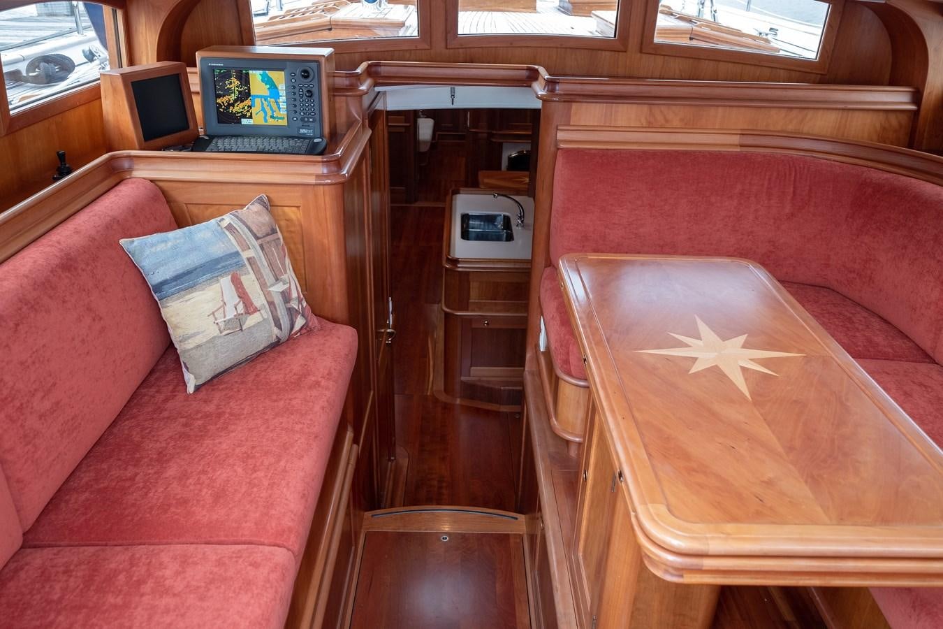 a room with a couch and a television on the wall aboard HOEK CLASSIC 73 DIXBAY Yacht for Sale