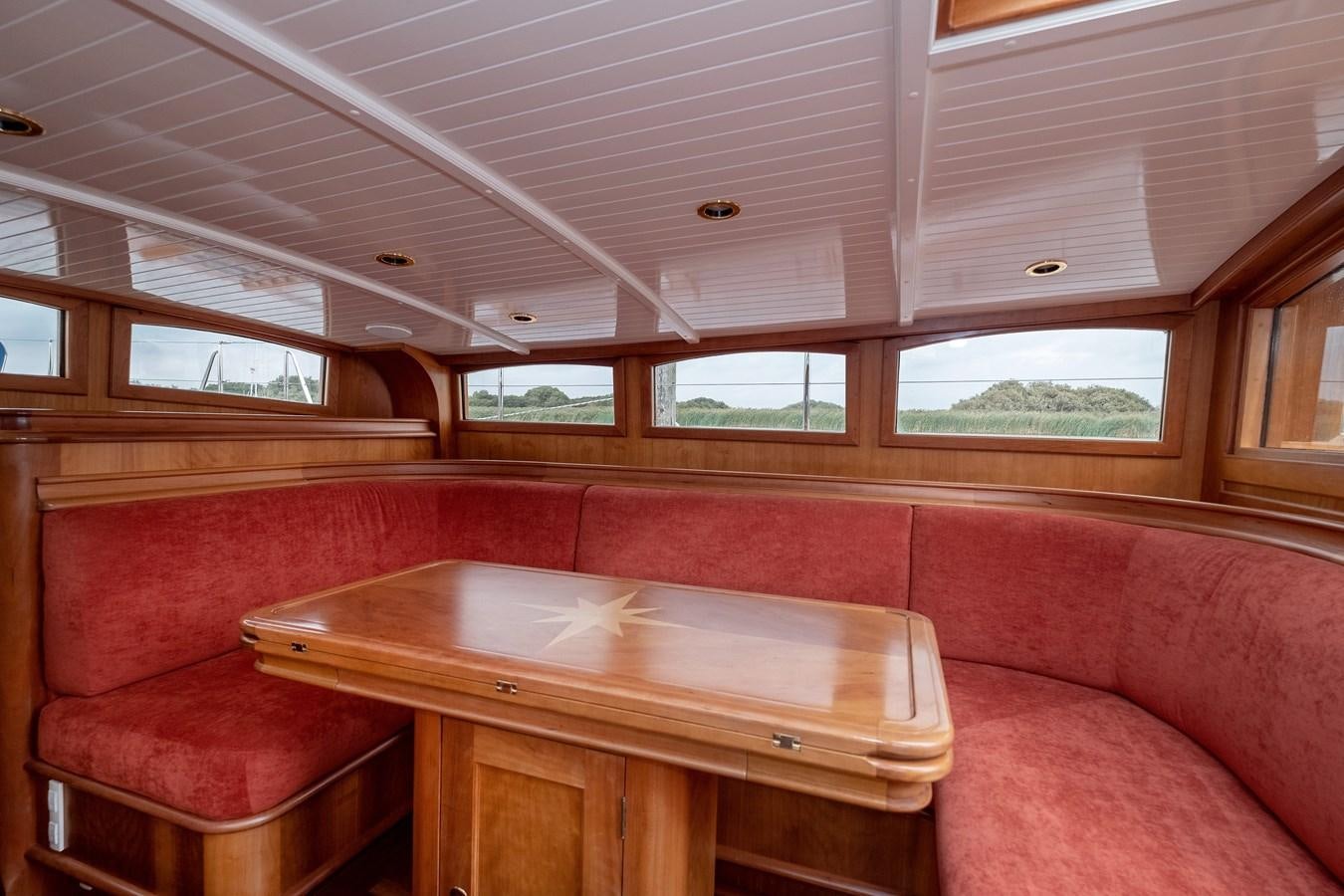 a table and chairs in a room aboard HOEK CLASSIC 73 DIXBAY Yacht for Sale