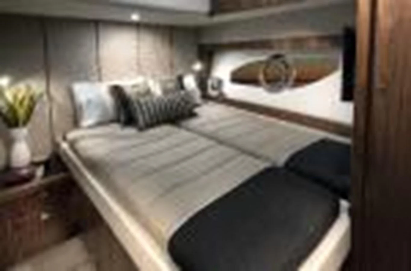 a room with a bed and a television aboard RIVIERA 72 SPORTS MOTOR YACHT Yacht for Sale
