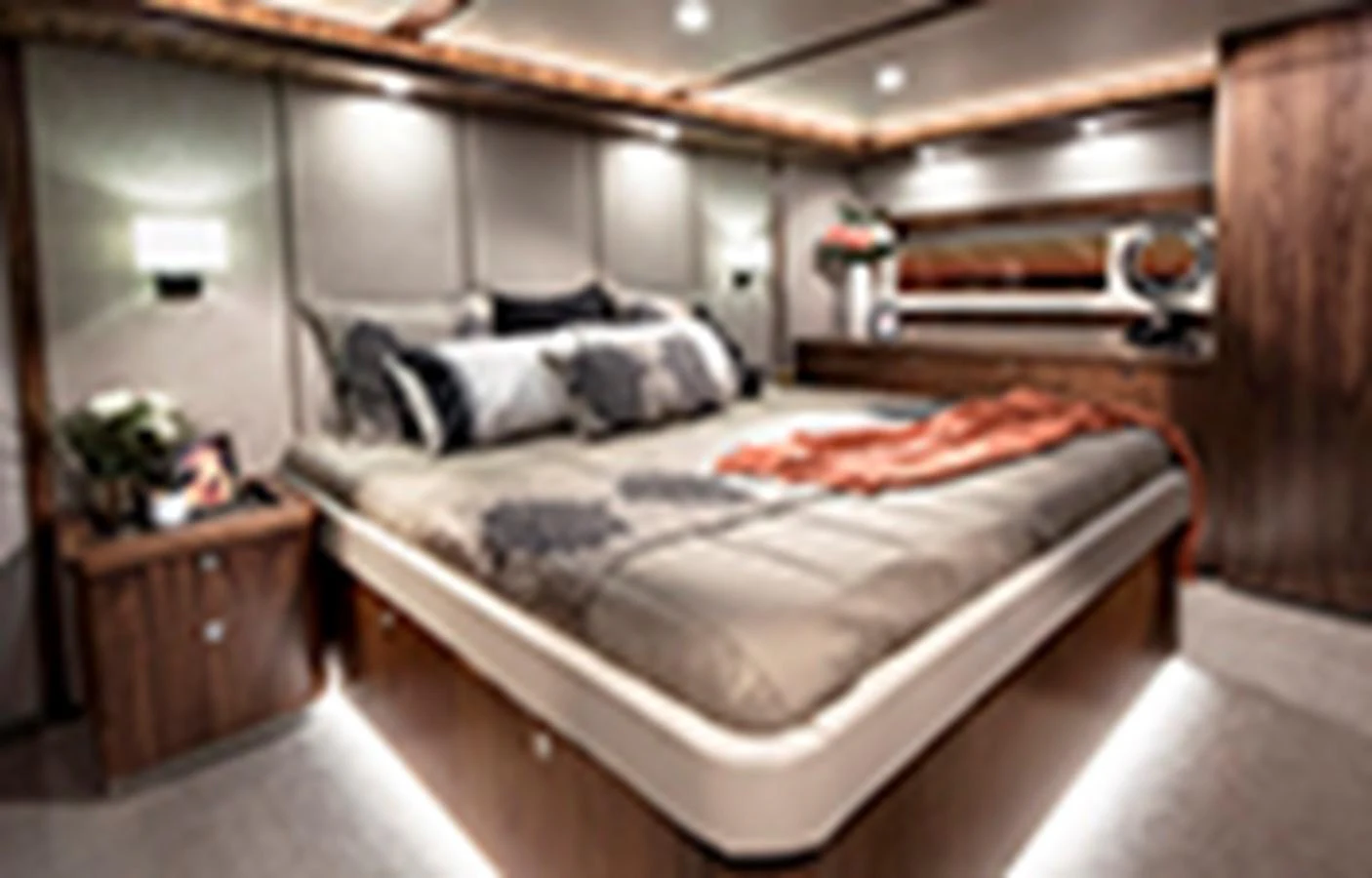 a bed with a white sheet and a red blanket on it aboard RIVIERA 72 SPORTS MOTOR YACHT Yacht for Sale