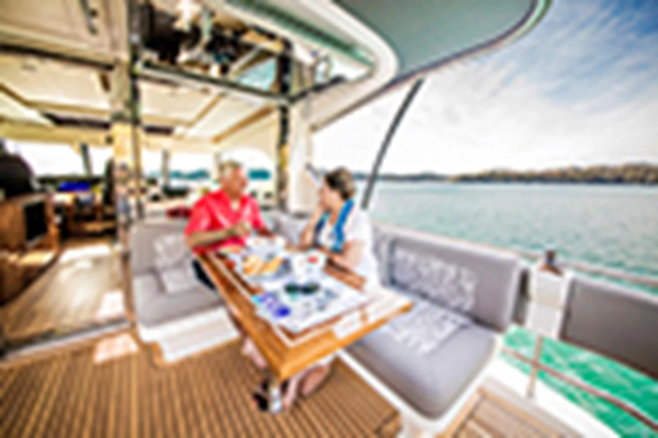 a couple sitting on a boat aboard RIVIERA 72 SPORTS MOTOR YACHT Yacht for Sale
