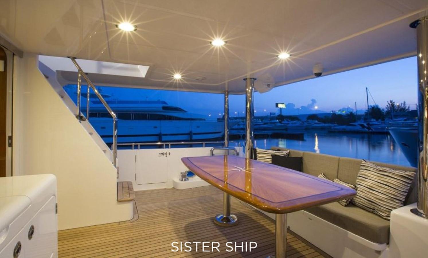 a pool with a table and a couch aboard 700 MY Yacht for Sale