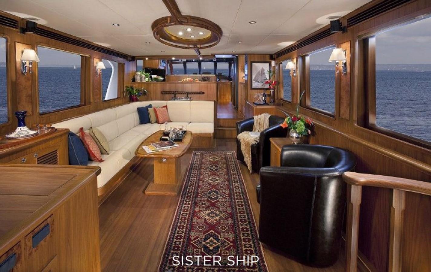 a living room with a couch and a table aboard 700 MY Yacht for Sale