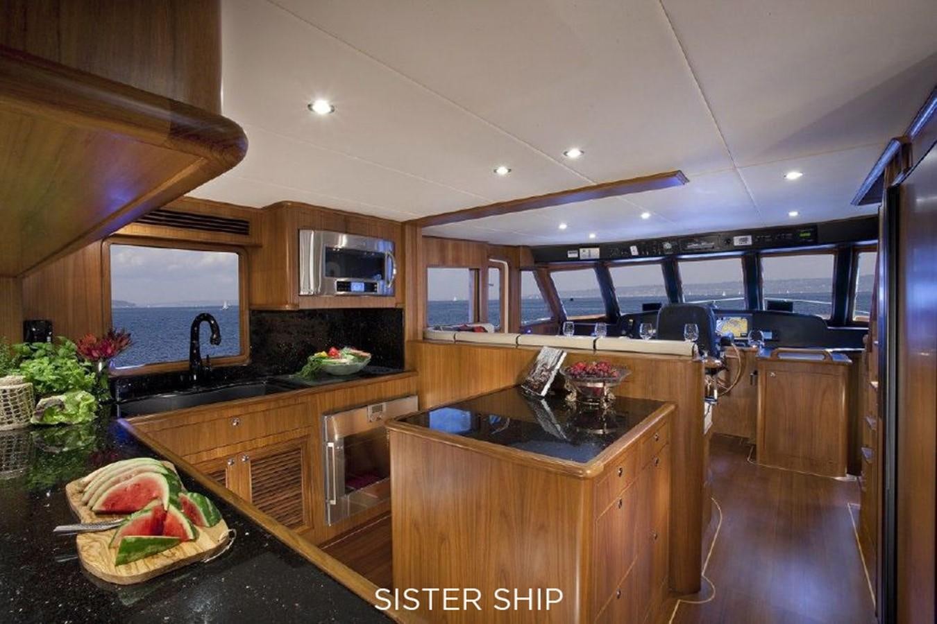 a kitchen with a large island aboard 700 MY Yacht for Sale
