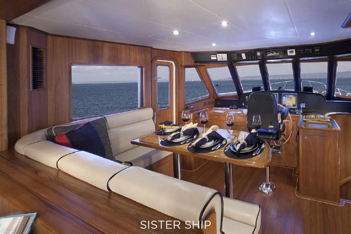 a room with a table chairs and a couch aboard 700 MY Yacht for Sale