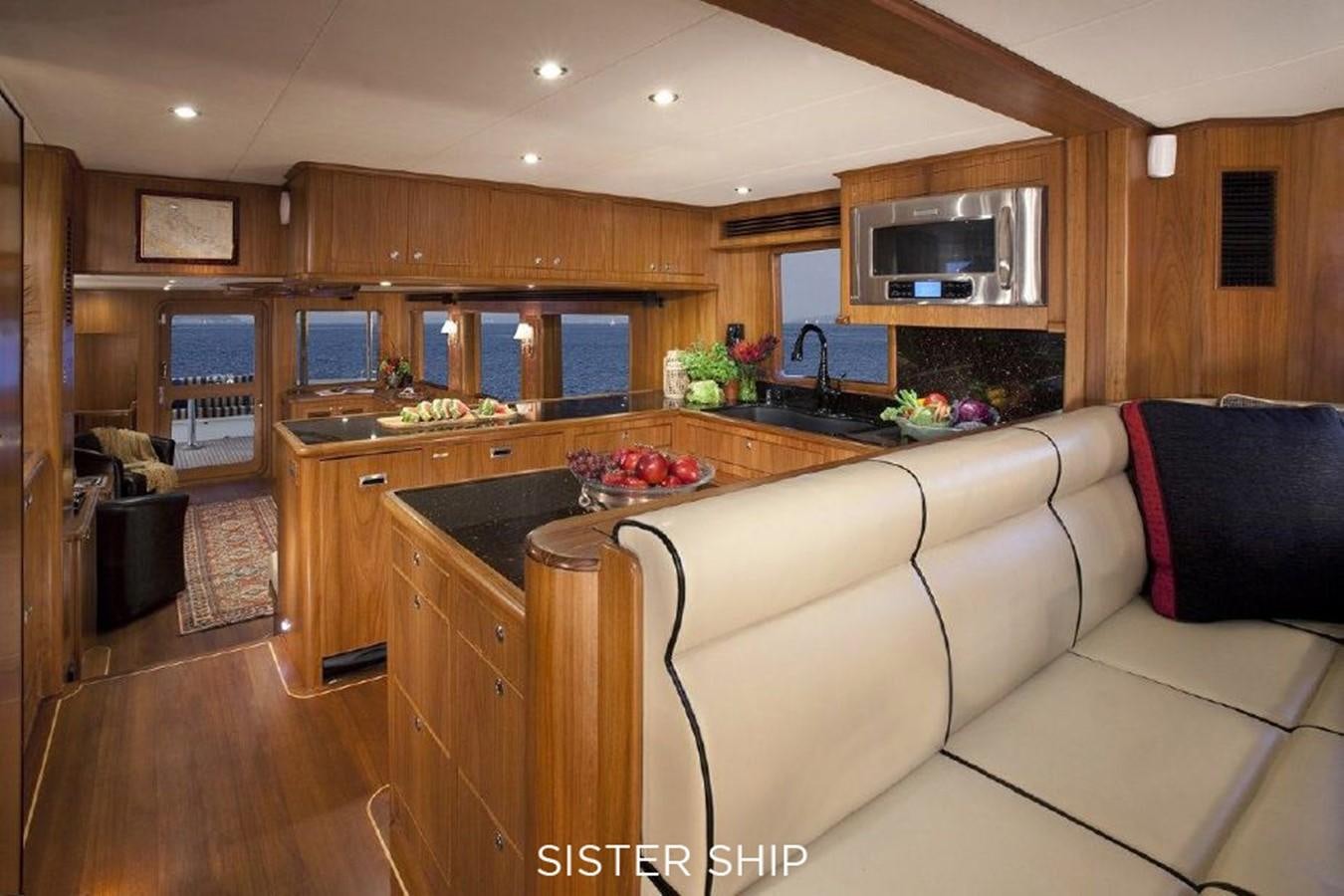 a kitchen with a white couch aboard 700 MY Yacht for Sale