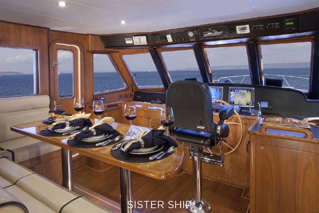 a room with a table and chairs aboard 700 MY Yacht for Sale