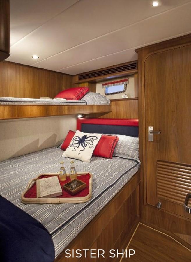 a bed with a tray on it aboard 700 MY Yacht for Sale