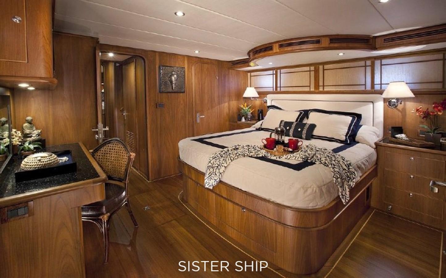 a bedroom with a bed and desk aboard 700 MY Yacht for Sale