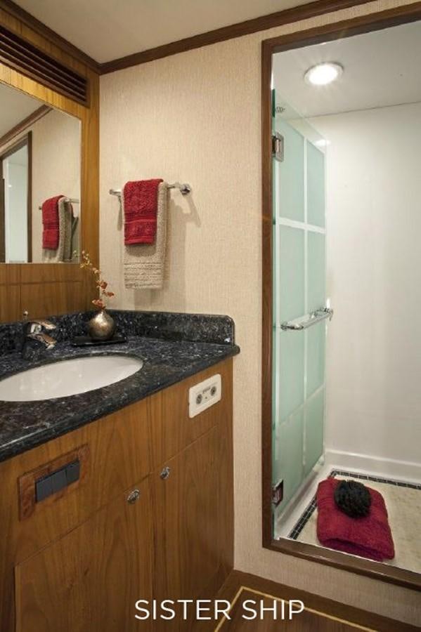 a bathroom with a sink and a mirror aboard 700 MY Yacht for Sale