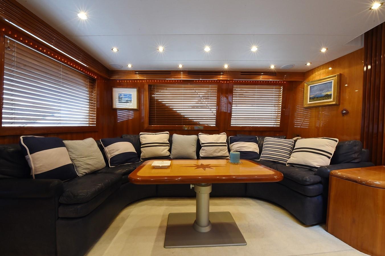 a living room with a couch and a coffee table aboard AMORE MIO 1 Yacht for Sale