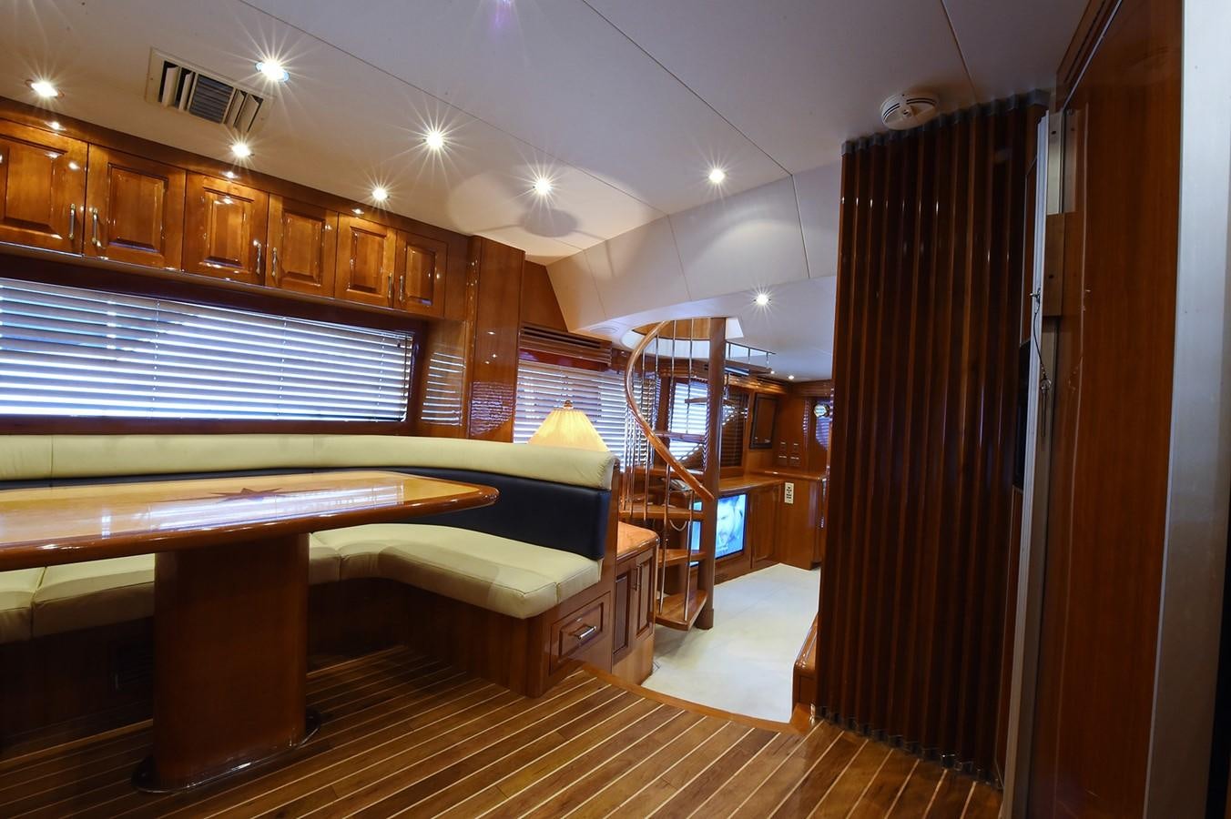 a room with a bar and a table and chairs aboard AMORE MIO 1 Yacht for Sale