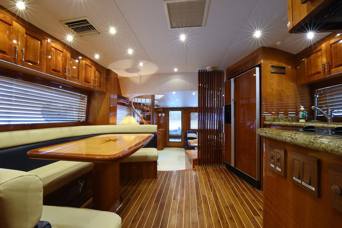 a kitchen with wooden cabinets aboard AMORE MIO 1 Yacht for Sale