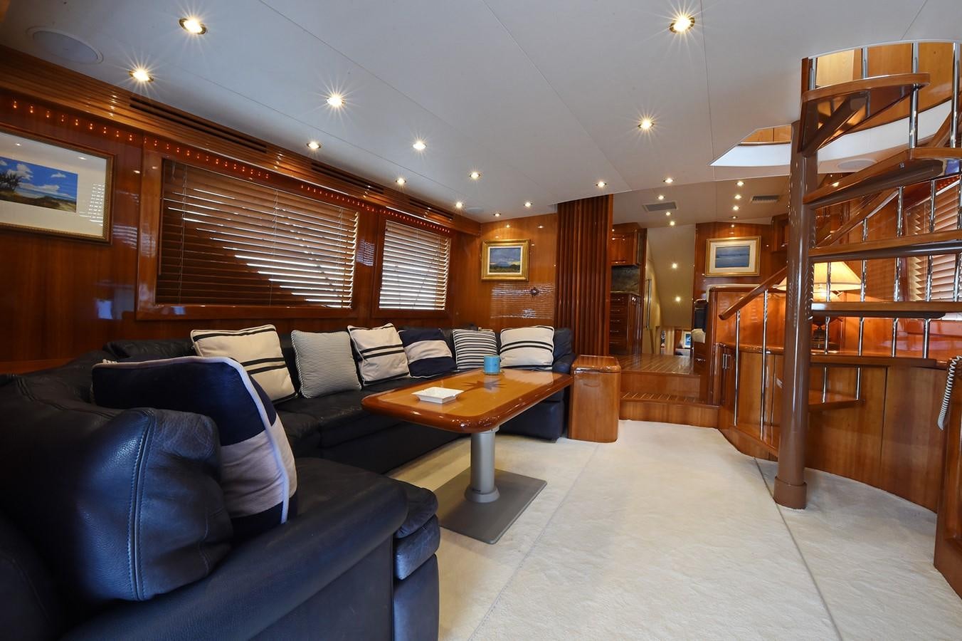 a living room with a couch and a table aboard AMORE MIO 1 Yacht for Sale