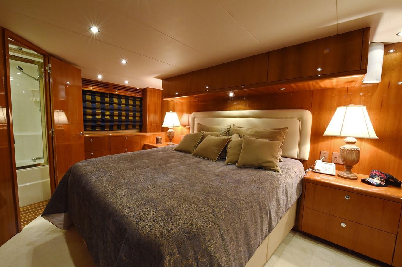 a bed with a lamp on it aboard AMORE MIO 1 Yacht for Sale