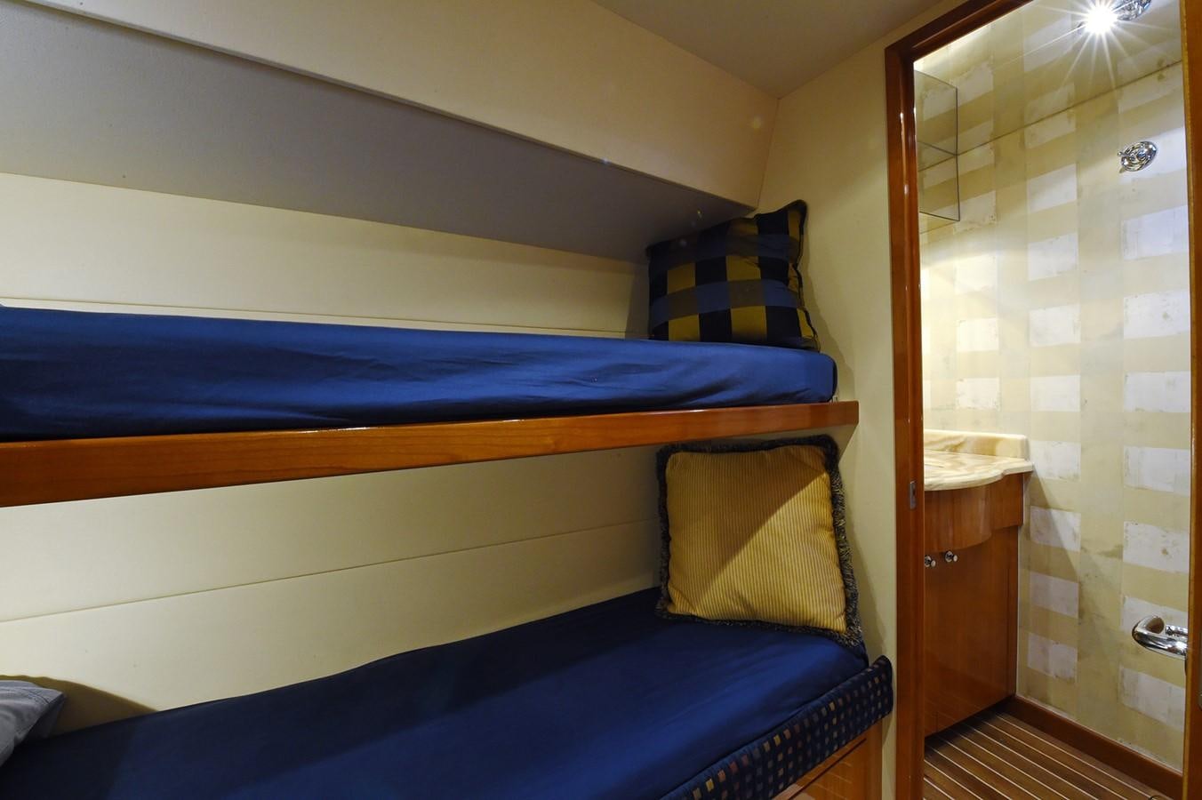 a bed with blue sheets aboard AMORE MIO 1 Yacht for Sale