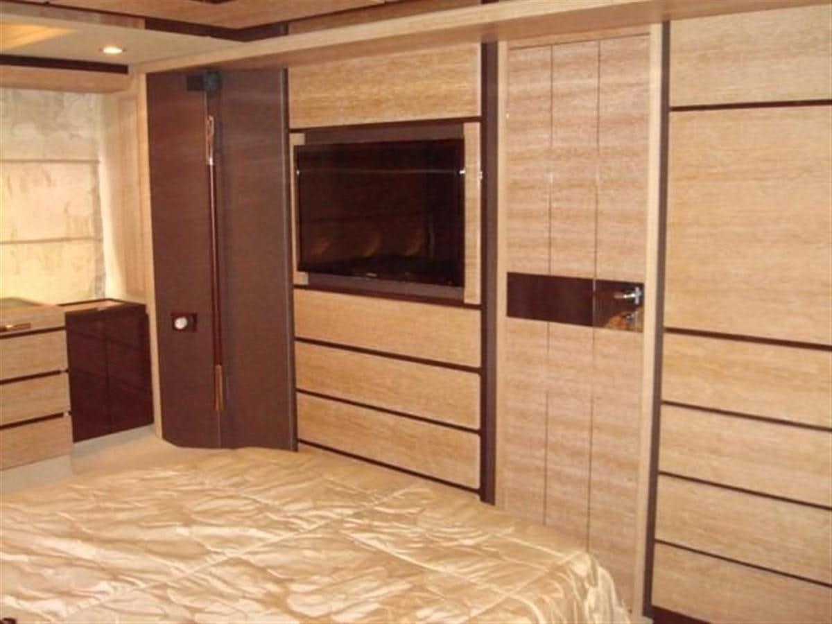 a room with a bed and a television aboard RAMAYA Yacht for Sale