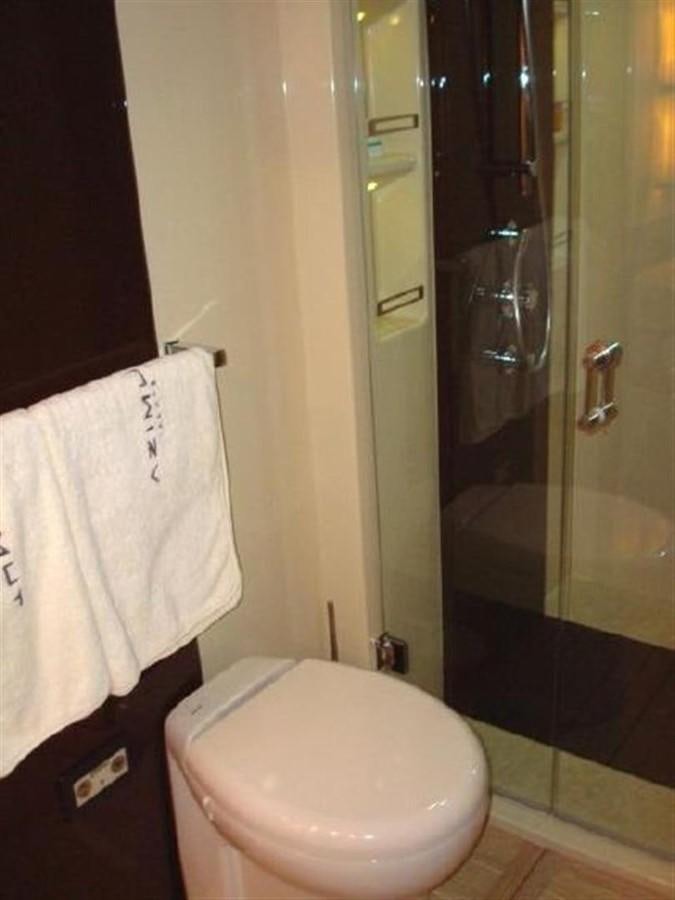 a bathroom with a toilet and towels aboard RAMAYA Yacht for Sale