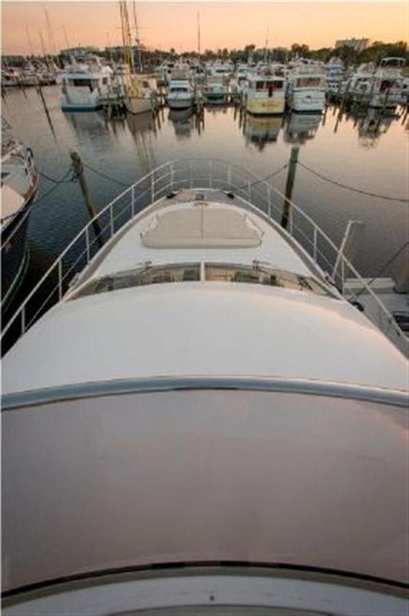 a large white boat in a harbor aboard RAMAYA Yacht for Sale