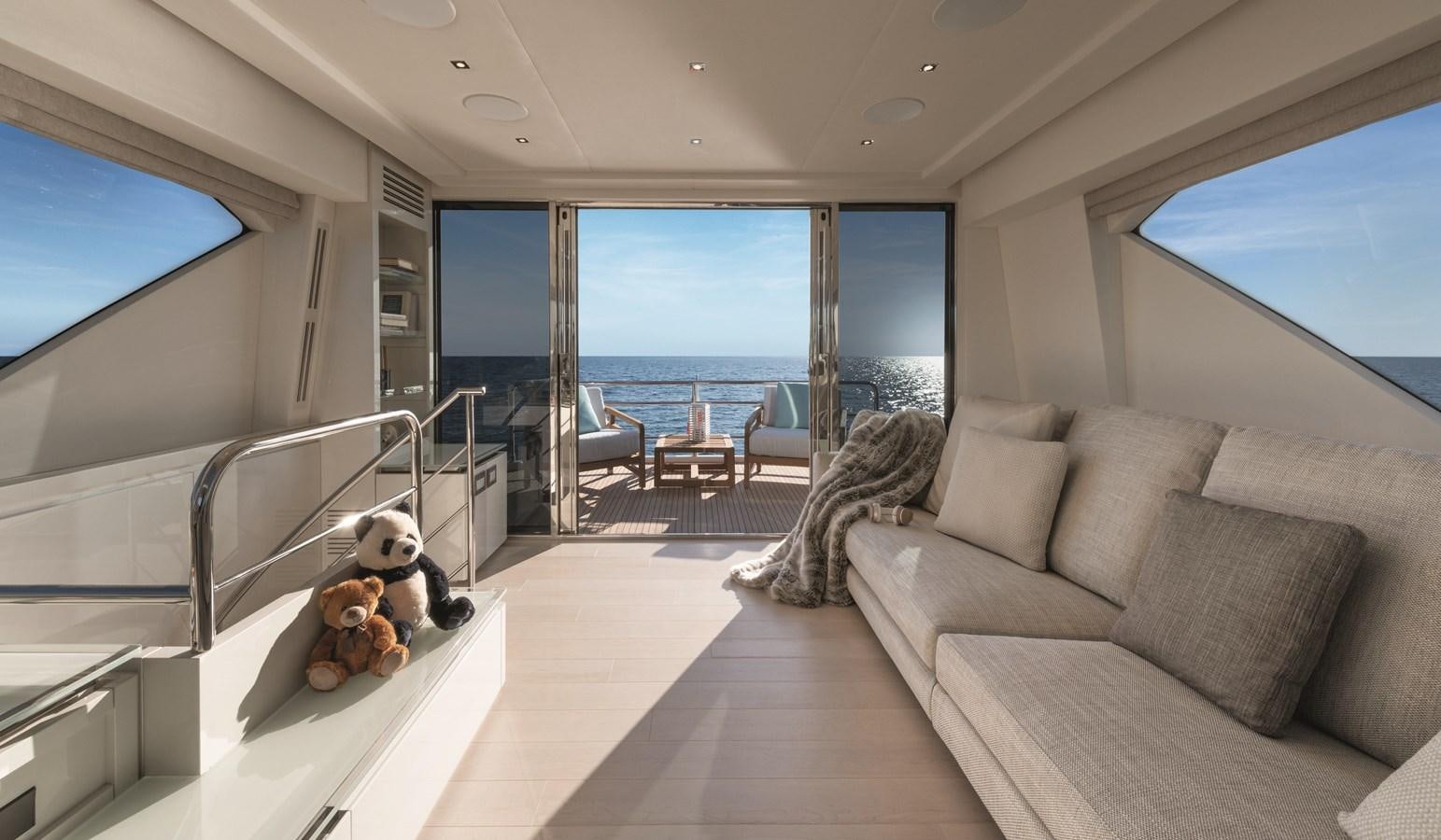 a large living room with a large balcony overlooking the ocean aboard MCY 70 SKYLOUNGE  Yacht for Sale