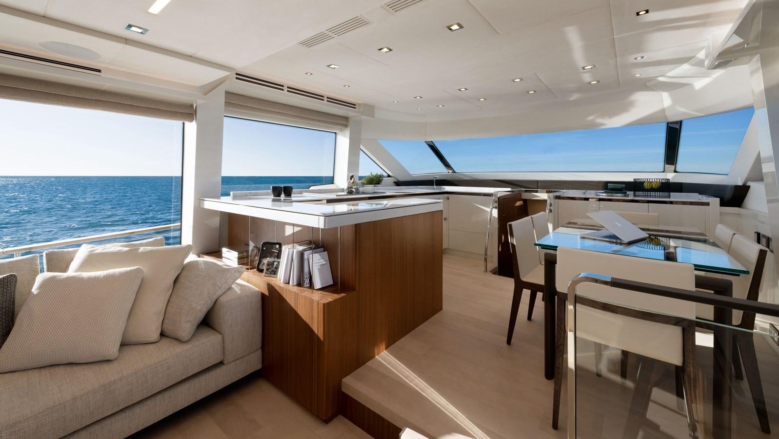 a room with a couch and a table and a large window aboard MCY 70 SKYLOUNGE  Yacht for Sale