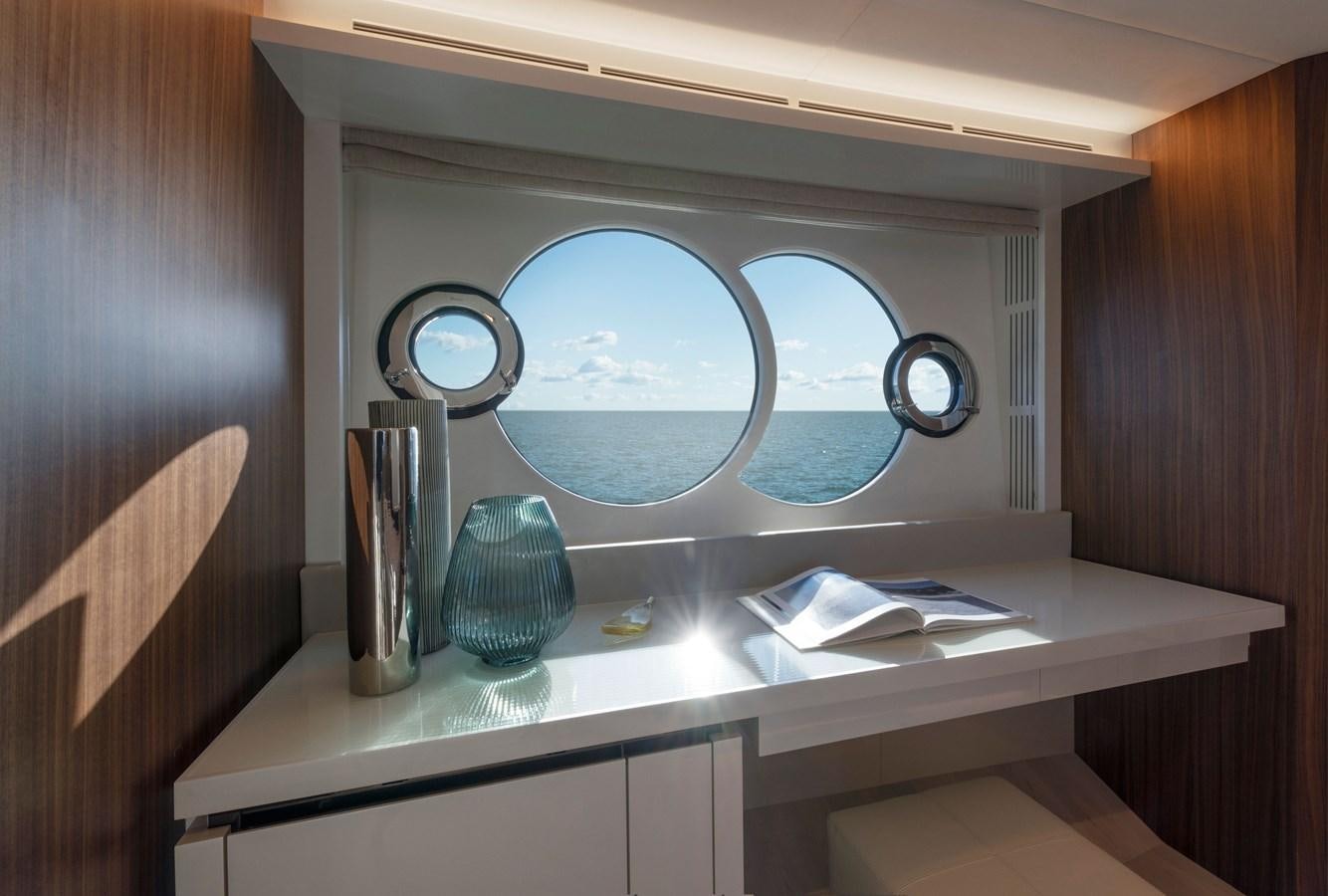 a white desk with a round mirror aboard MCY 70 SKYLOUNGE  Yacht for Sale