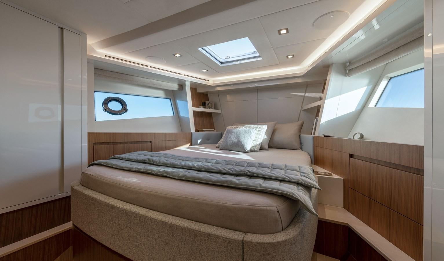 a room with a bed and a window aboard MCY 70 SKYLOUNGE  Yacht for Sale