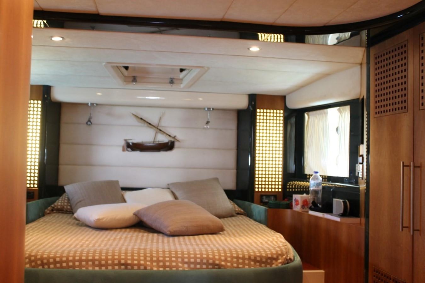 a bedroom with a bed and a desk aboard MACAMI Yacht for Sale
