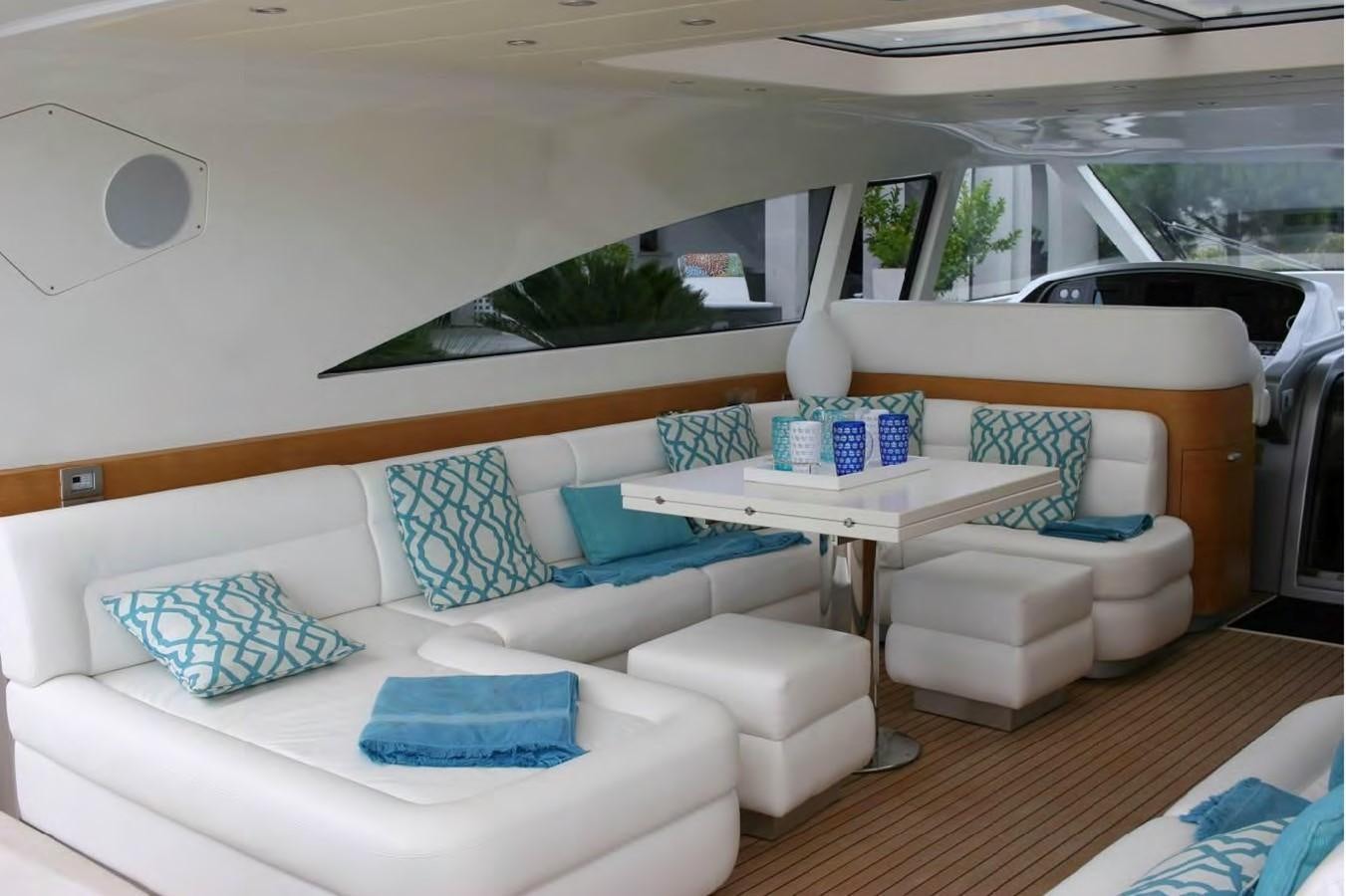 a living room with a white couch and a table aboard FOX Yacht for Sale