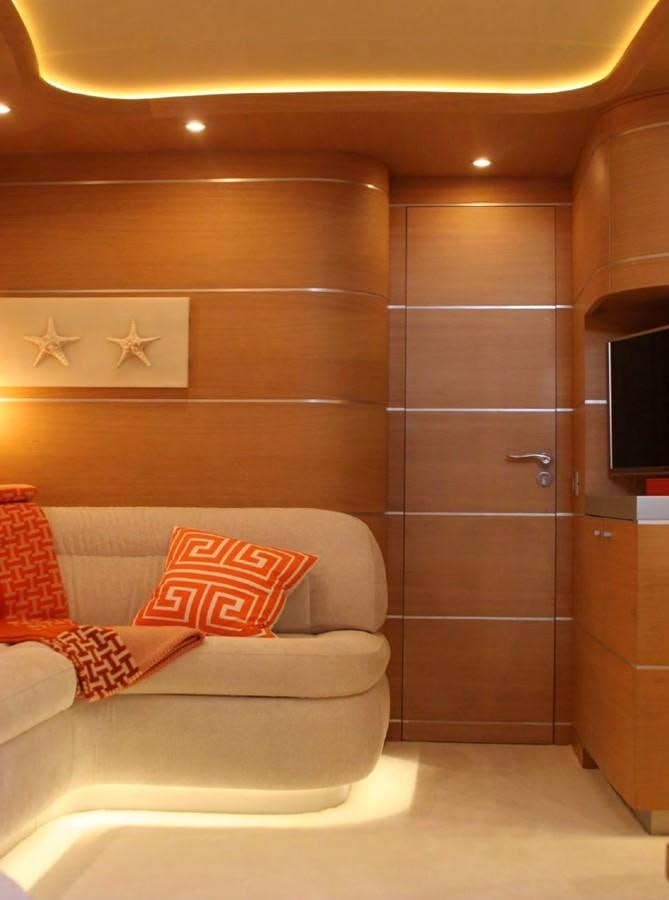 a room with a bed and a television aboard FOX Yacht for Sale
