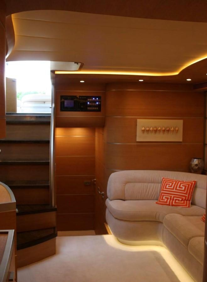 a room with a couch and a shelf with a bookcase aboard FOX Yacht for Sale