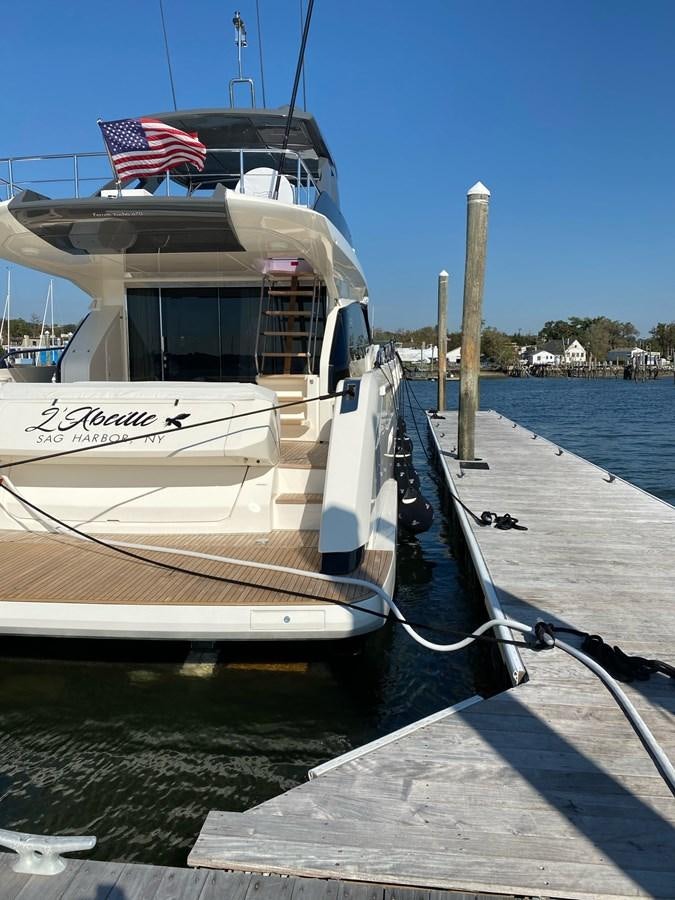 a boat docked at a pier aboard L’ABEILLE Yacht for Sale