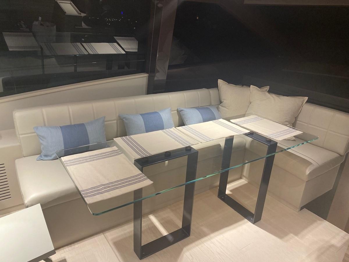 a table with a couch and a chair aboard L’ABEILLE Yacht for Sale